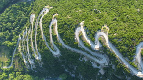 the winding road with multiple curves leads toward papigko village in the picturesque mountainous region of zagori, located in the epirus region of greece, europe