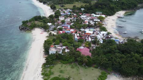 drone flyover above guimbitayan fishing village north of malapascua island