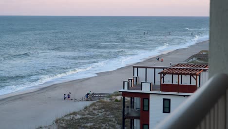 wide shot from a balcony overlooking carolina beach, nc to the south at sunset