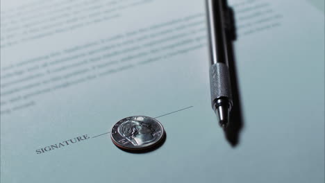 close up low angle shot of a spinning quarter on a document or contract