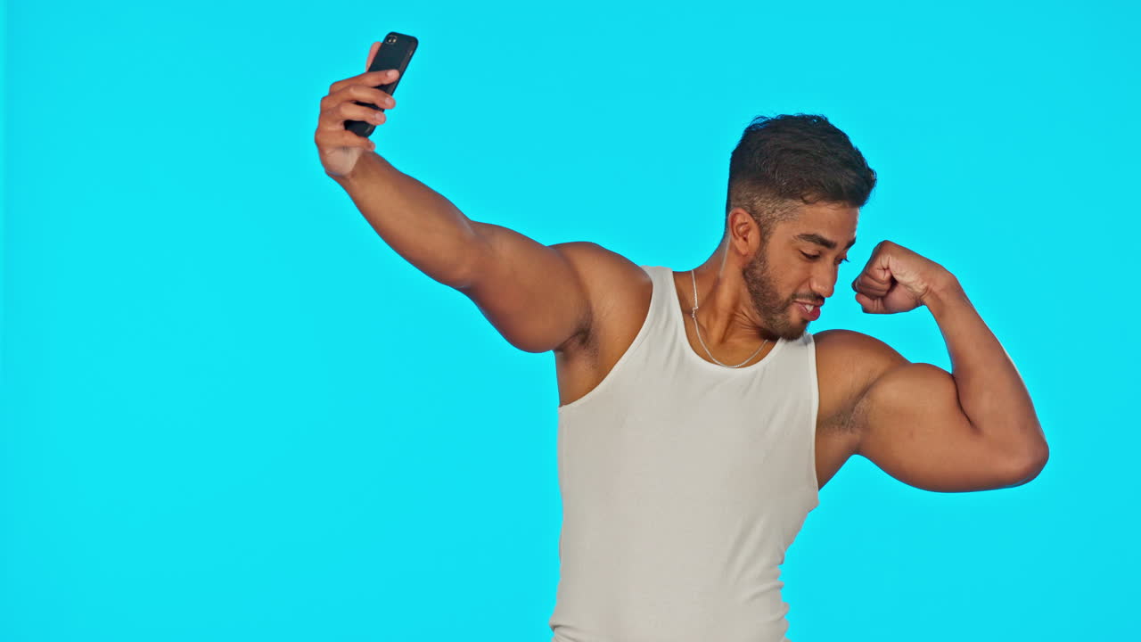 Selfie, smile and bicep muscle of man in studio