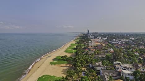 negombo sri lanka aerial v6 drone flyover golden sand browns beach capturing oceanfront hotels and residential houses along the long stretches of sandy beach - shot with mavic 3 cine - april 2023