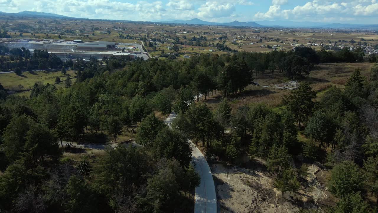 Dolly out bird's eye view of a lonely forest outside Almoloya, Mexico state, full panoramic view of the mountains