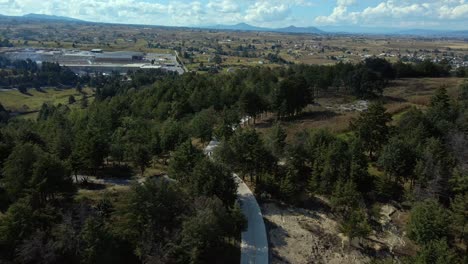 Dolly-out-bird's-eye-view-of-a-lonely-forest-outside-Almoloya,-Mexico-state,-full-panoramic-view-of-the-mountains