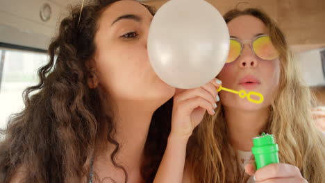 a group of friends having fun blowing bubbles