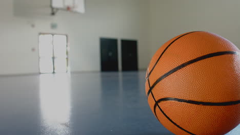 basketball on gym floor in empty court, ready for game or practice, copy space