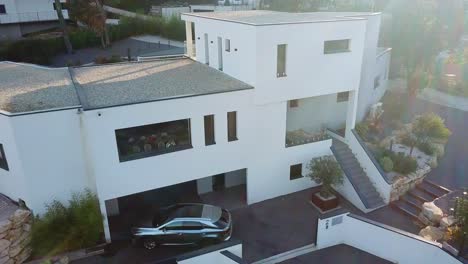 drone captures grandeur of white sunkissed luxurious french villa house