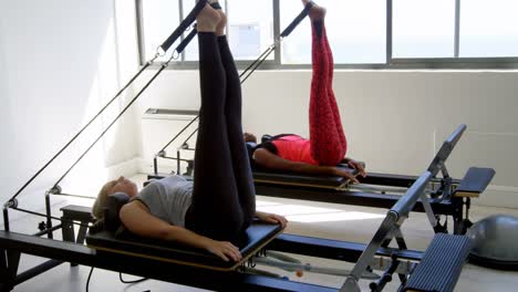 women exercising on rowing machine 4k