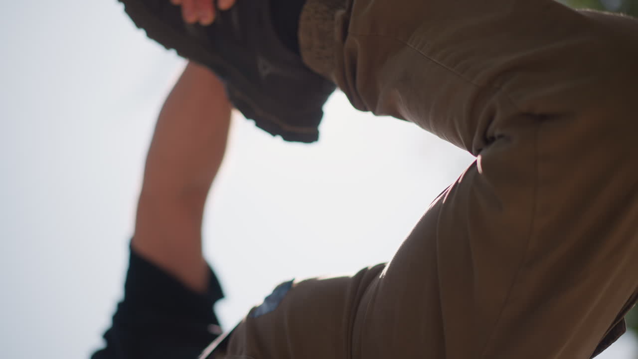 Slow Warmup Stretch Involving Leg Muscles, Relaxed Leg Extension Exercise During Outdoor Warmup Session, Calm And Controlled Quad Stretch To Improve Flexibility And Promote Recovery Outdoors