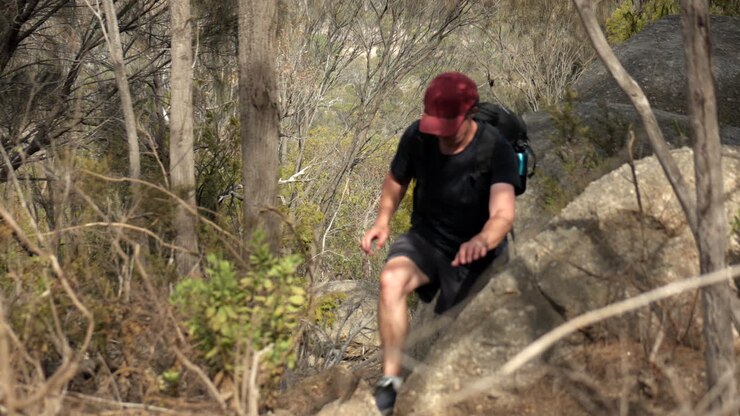 Man climbs up rugged track at the You Yangs National Park, Victoria Australia