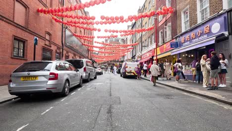 busy street with cars and pedestrians in chinatown