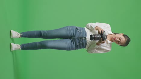 woman photographer on green screen