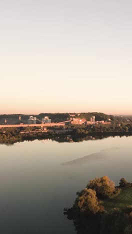 industrial landscape by the river at sunrise/sunset
