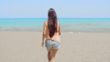 Happy-Woman-at-the-Beach-Waving-at-the-Camera