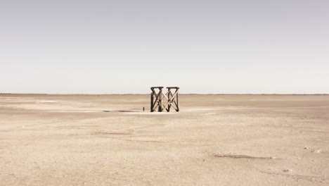 drone heading towards a timber object at the beach