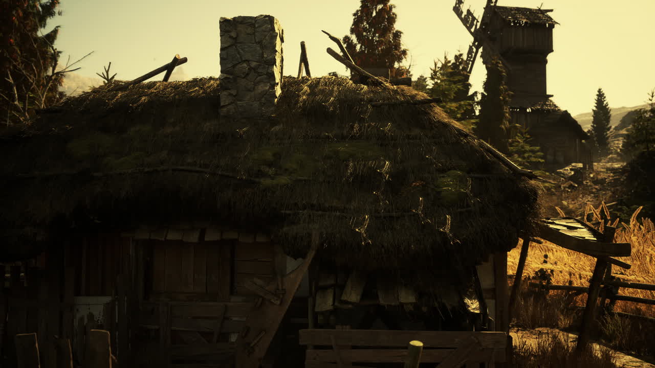 Rustic countryside cottage surrounded by golden fields at sunset