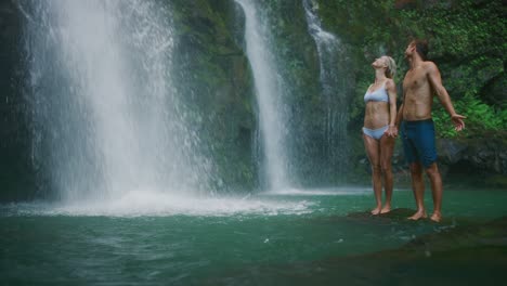 young couple exploring waterfalls