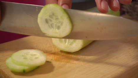 Cucumber-slowly-sliced-on-a-cutting-board