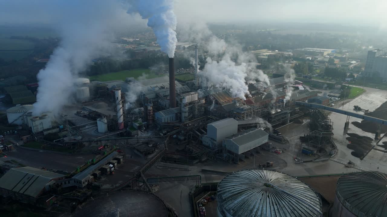 Aerial footage of expansive sugar manufacturing facility in Bury St Edmunds with silos and machinery for large scale food production UK