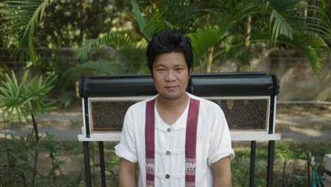 portrait of an asian man in traditional clothing outdoors