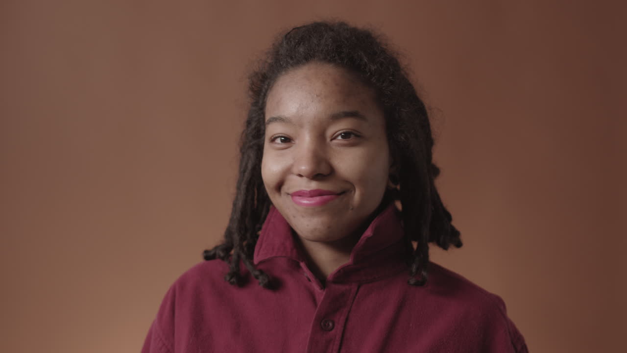 Portrait of Beautiful African-American Woman Fixing the Collar