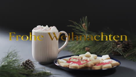 frohe weihnacthen texto en oro sobre la chocolate caliente de navidad y galletas