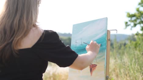 woman painting boats on a canvas outdoors
