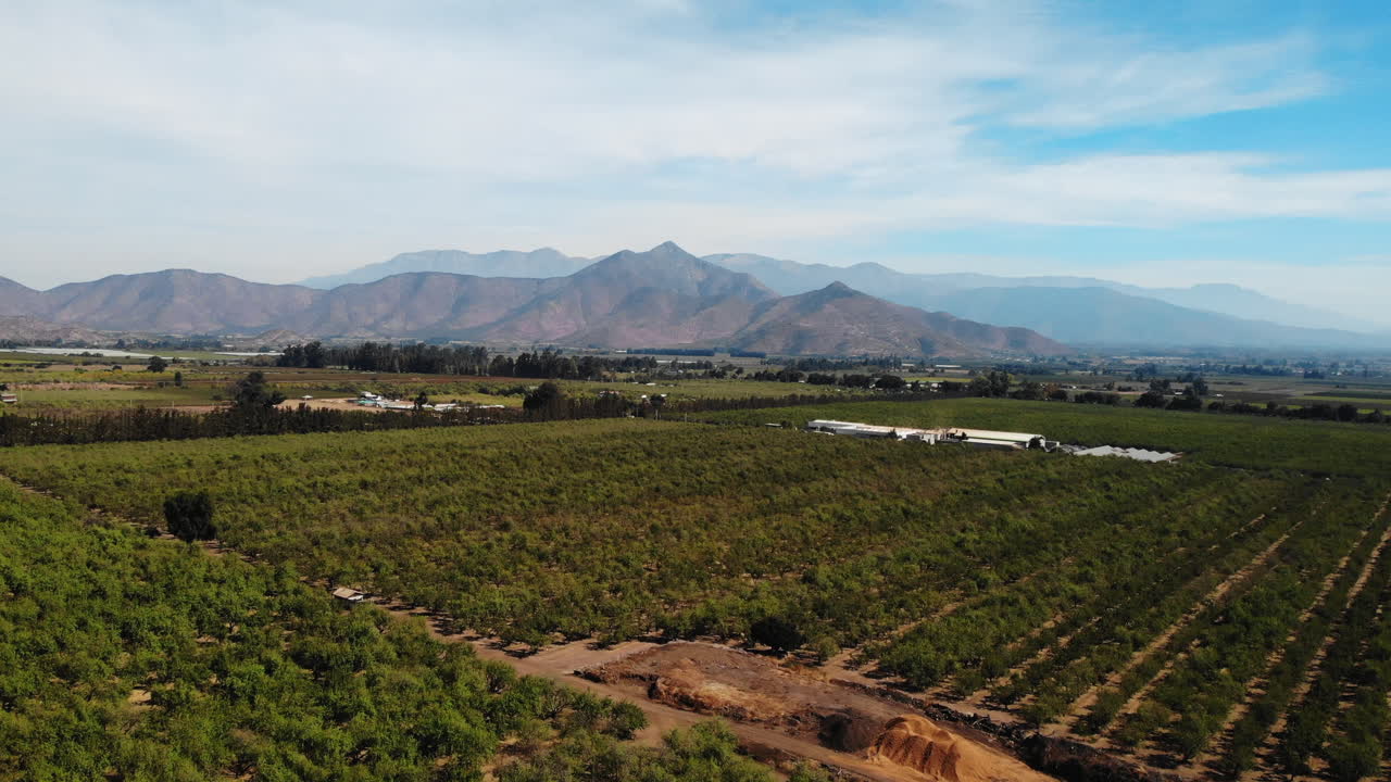 Aerial view of farmland with mountains in the background