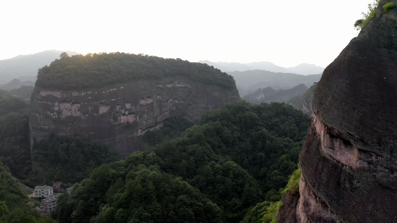 Aerial: Bajiaozhai shan mountain valley in China countryside, sunset landscape