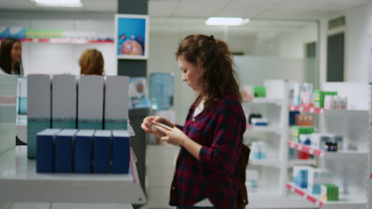Woman shopping for medication in a pharmacy