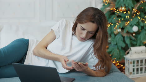 serious business woman looking computer screen in luxury bedroom.