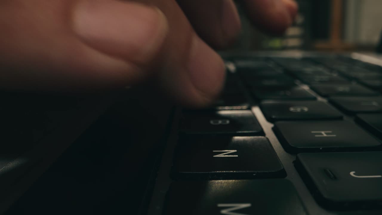 Closeup of hands typing on a laptop, showcasing productivity and advanced technology in a modern workspace