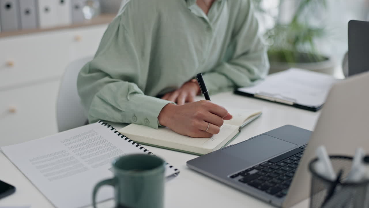business person, hands and writing in notebook