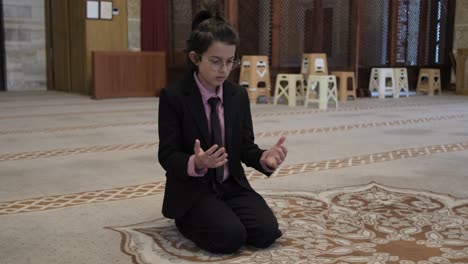 boy praying in mosque