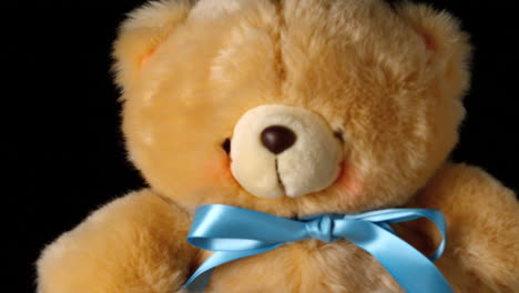 Teddy-bear-falling-on-black-background-close-up