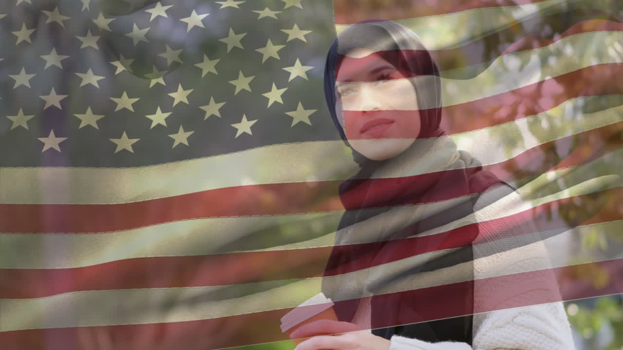 Animation of American flag waving over biracial woman in hijab holding takeaway coffee cup