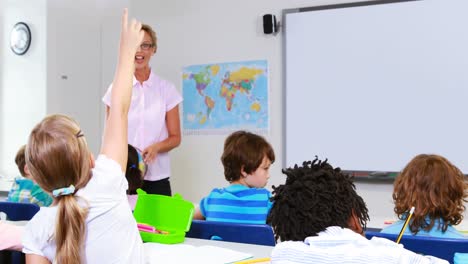 School-kids-raising-hand-in-classroom