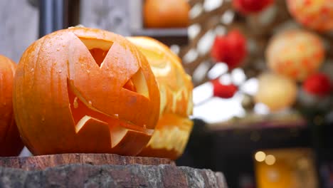 A carved pumpkin sits outdoors in daylight on Halloween, spooky, festive charm, lanterns swaying in the background