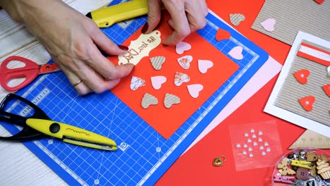 hands of girl making scrap valentine greeting card