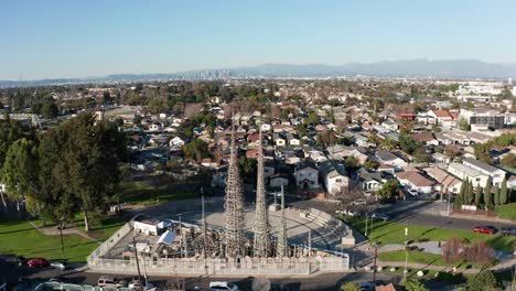 aerial push-in and tilting down shot of the watts towers in los angeles, california