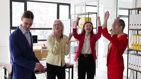 celebrating success: a diverse business team in a modern office