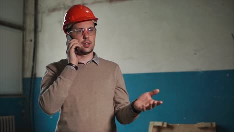 construction worker on phone in industrial setting