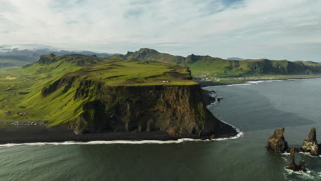 icelandic coastal cliffs and black sand beach
