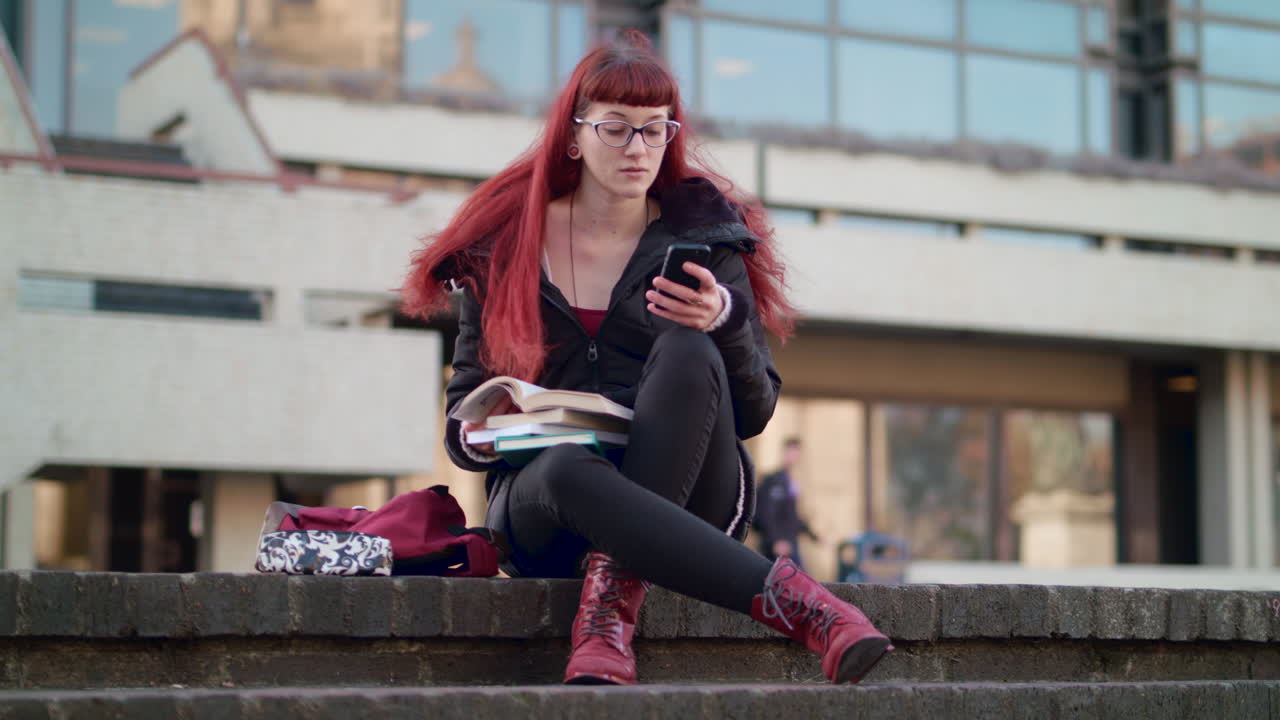 Young woman caught playing with phone when she should be studying - in slow motion
