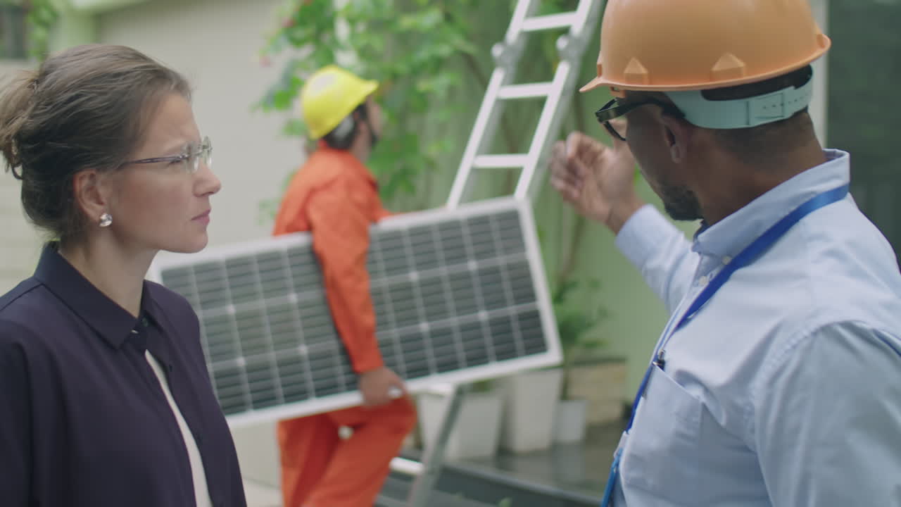 Engineer Discussing with Woman Solar Panels Installation