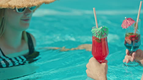 couple enjoying cocktails in a pool