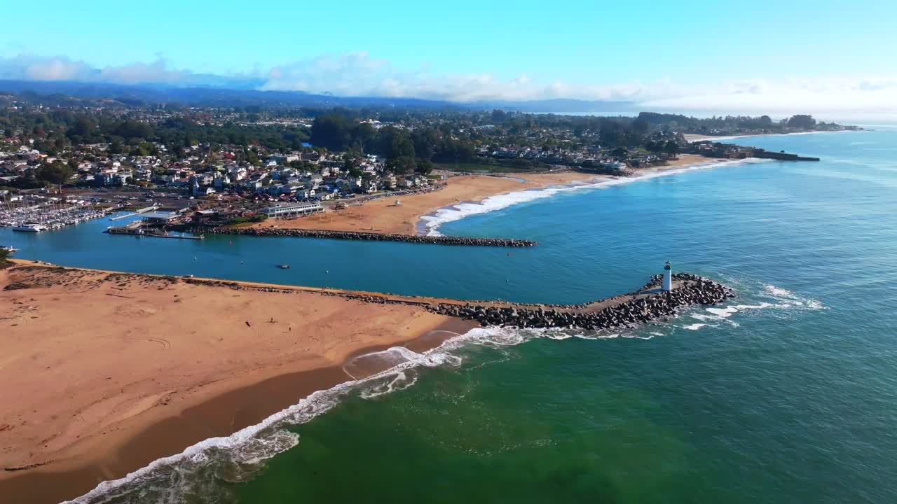 SeaBright Blacks Beach Walton Lighthouse Monterey Bay Santa Cruz California aerial drone scenic landscape deep blue surf waves sand Pacific Ocean Pleasure Point morning blue sky mist fog circle right
