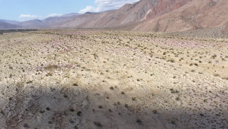 Vast-Fat-Badlands-Surrounded-by-Mountains,-Drone-Shot