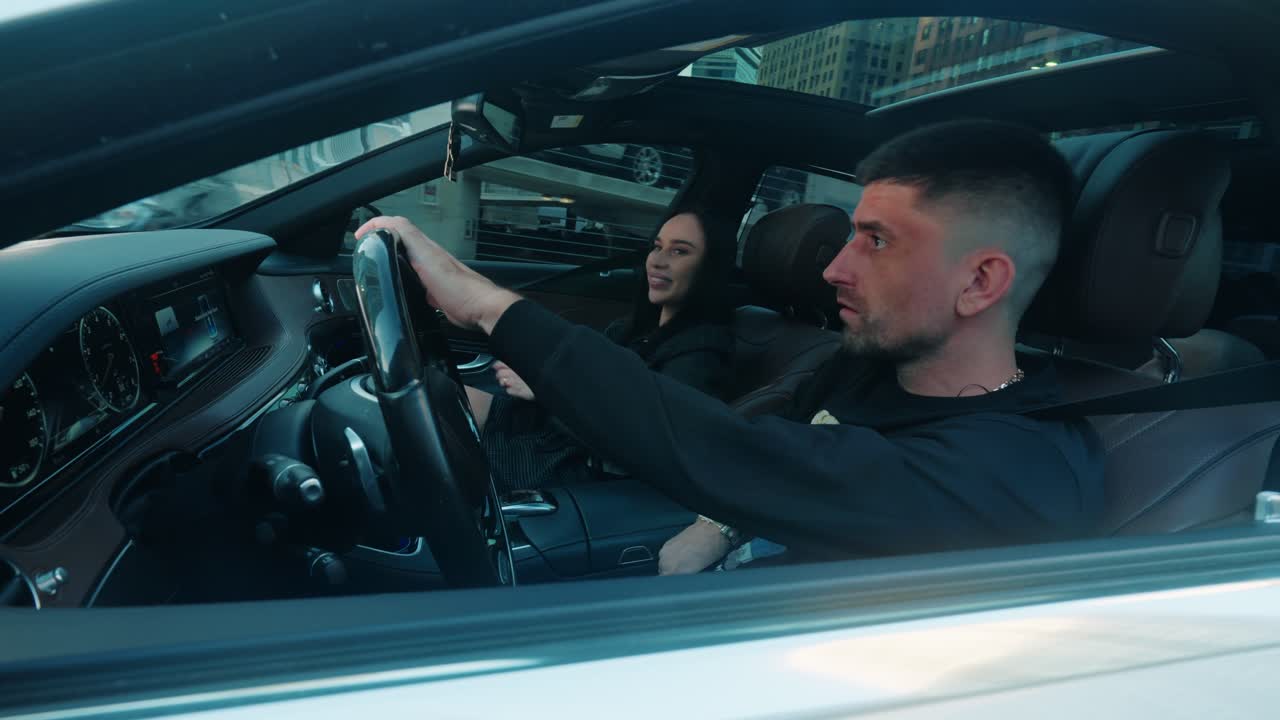 Couple Buckling Up Inside Car Before Driving Off in Downtown Chicago