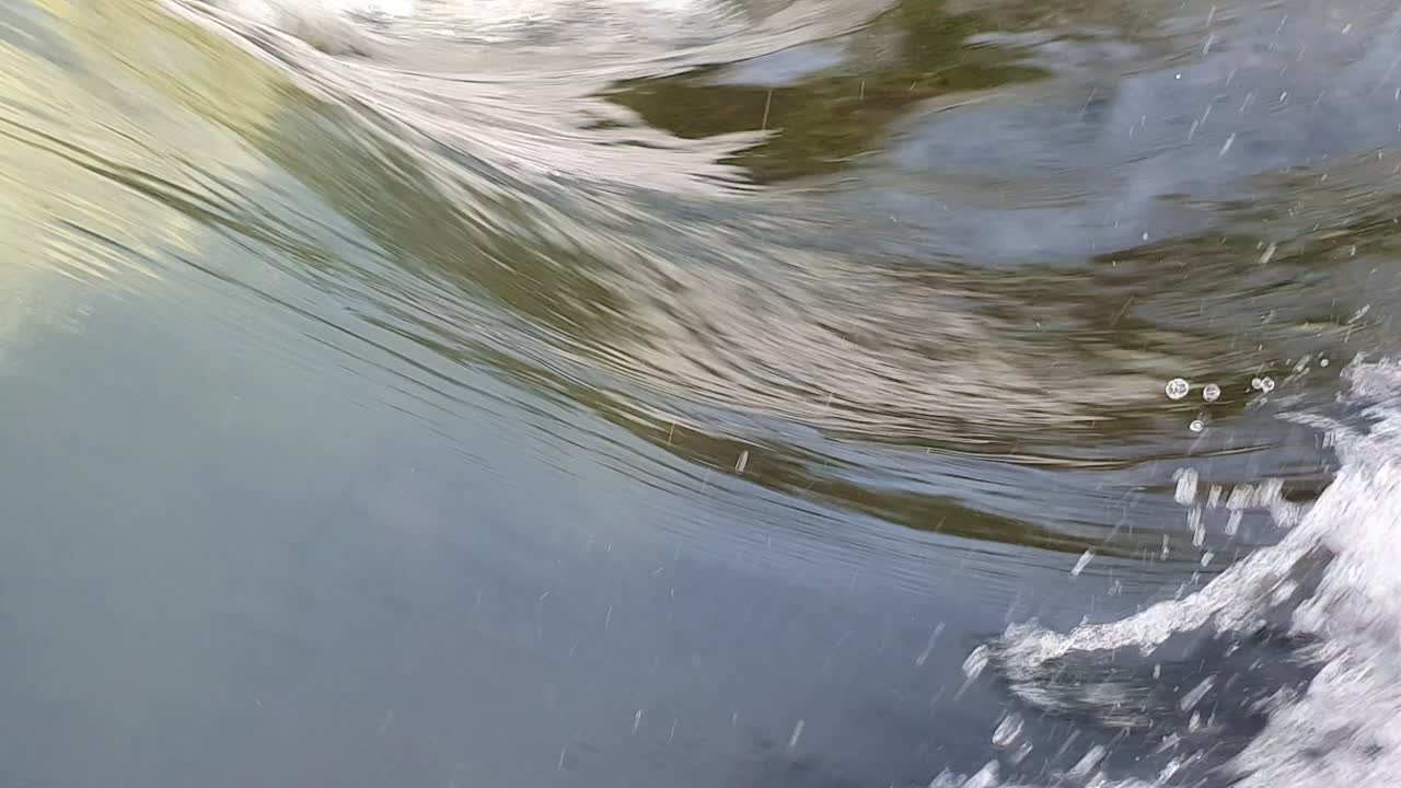 Close up of fresh water streaming over a weir, abstract and mesmerizing